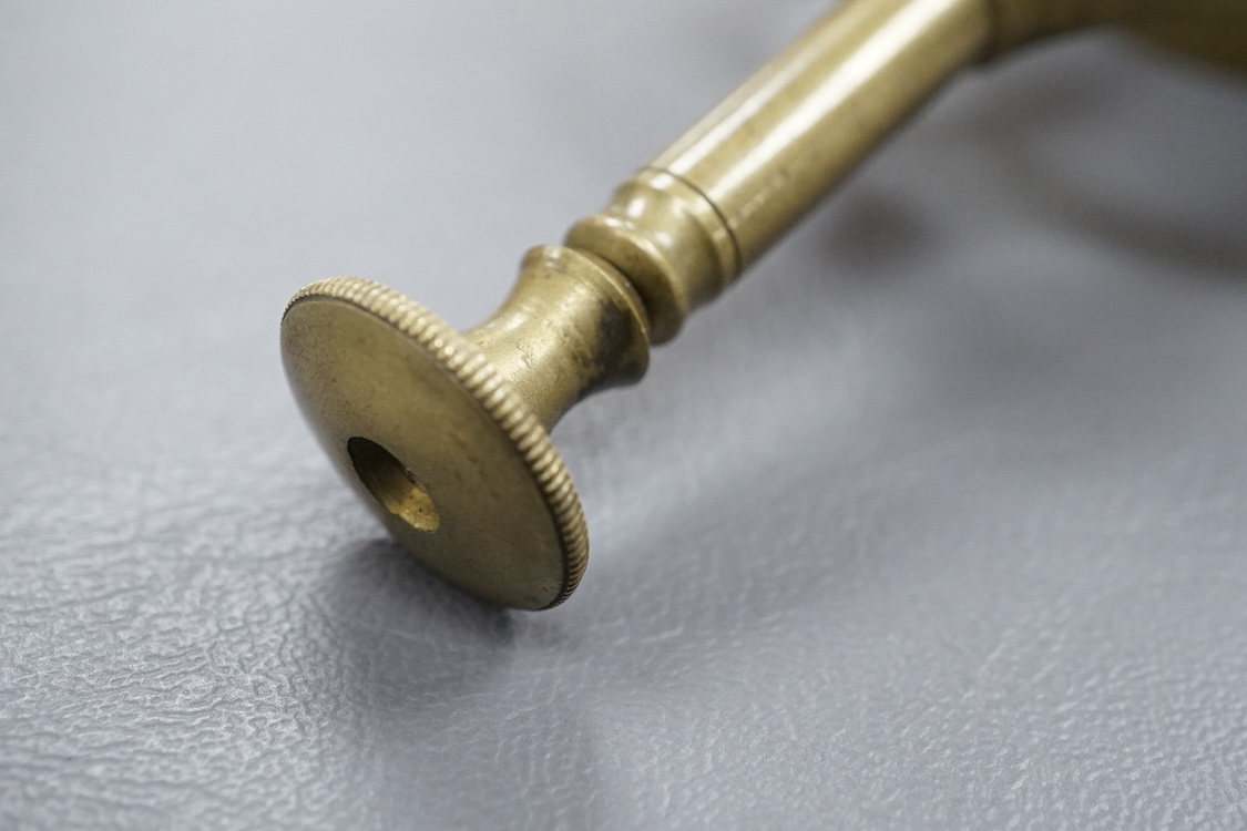 A late 19th/early 20th century brass watchmaker's uprighting tool, 21cm.